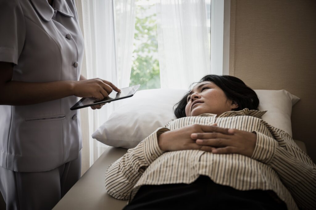 Young Nurse take care for elderly patients during hospital admission.